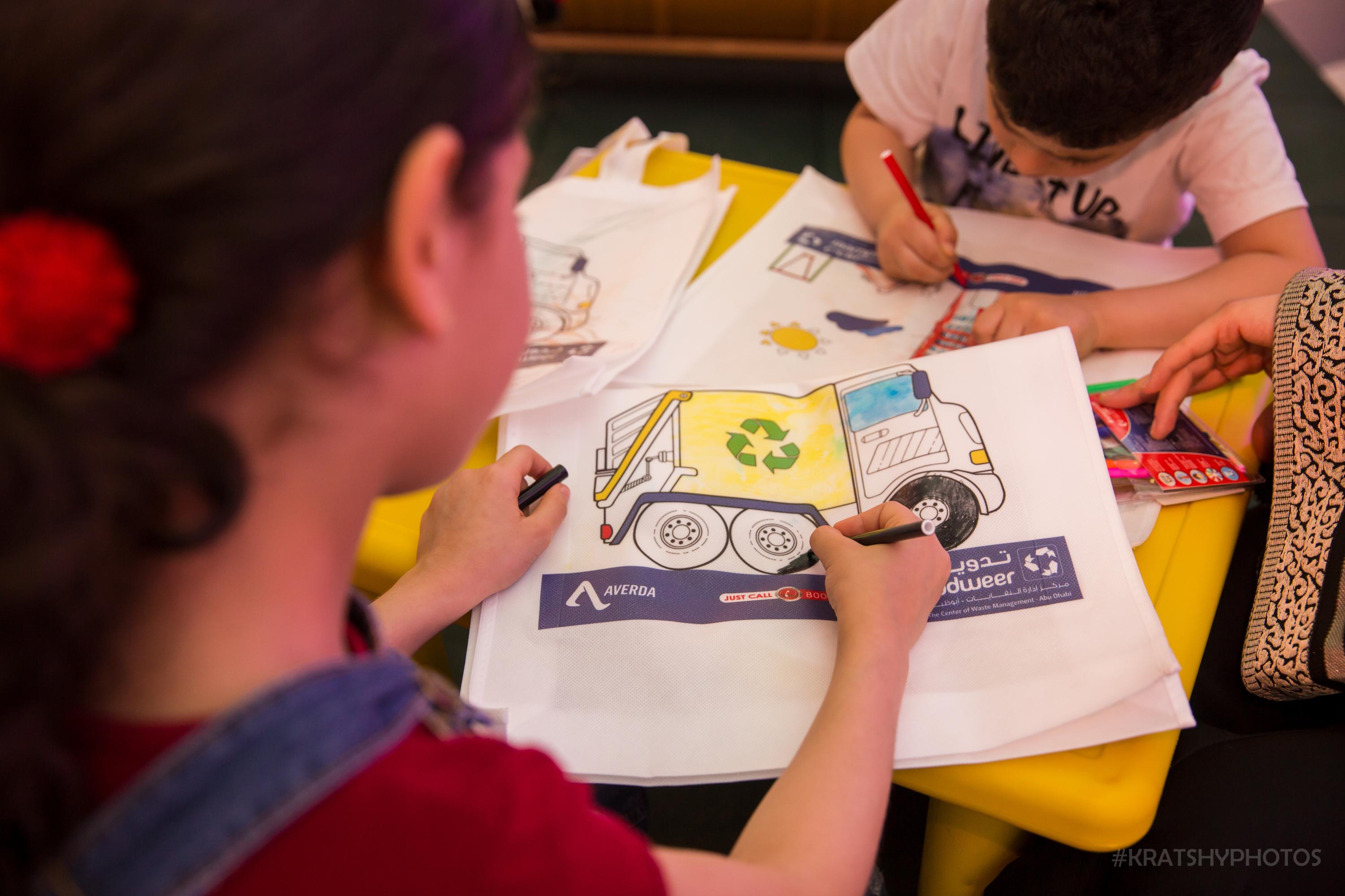 Children colouring a boook